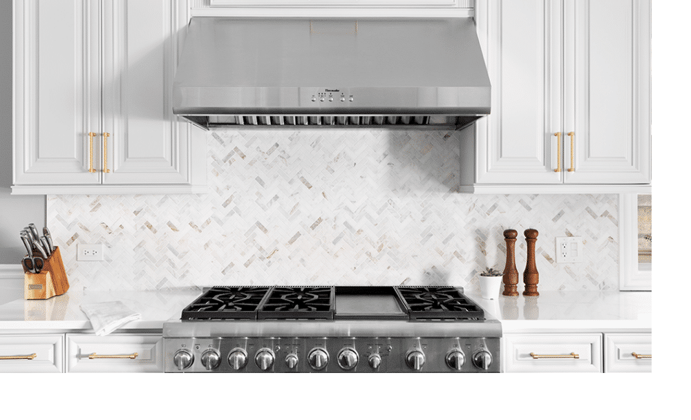 bright white kitchen featuring stainless steel range and vent hood